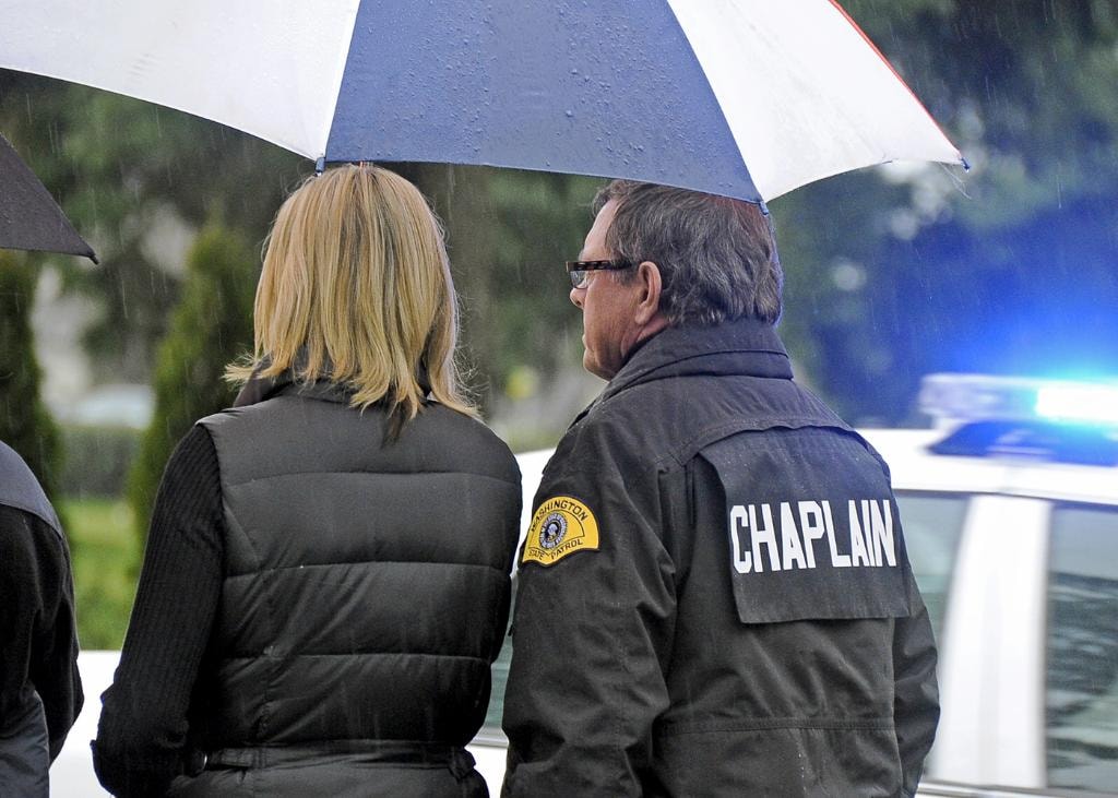 Mike Neil in CHAPLAIN jacket at an outdoor scene in the rain
