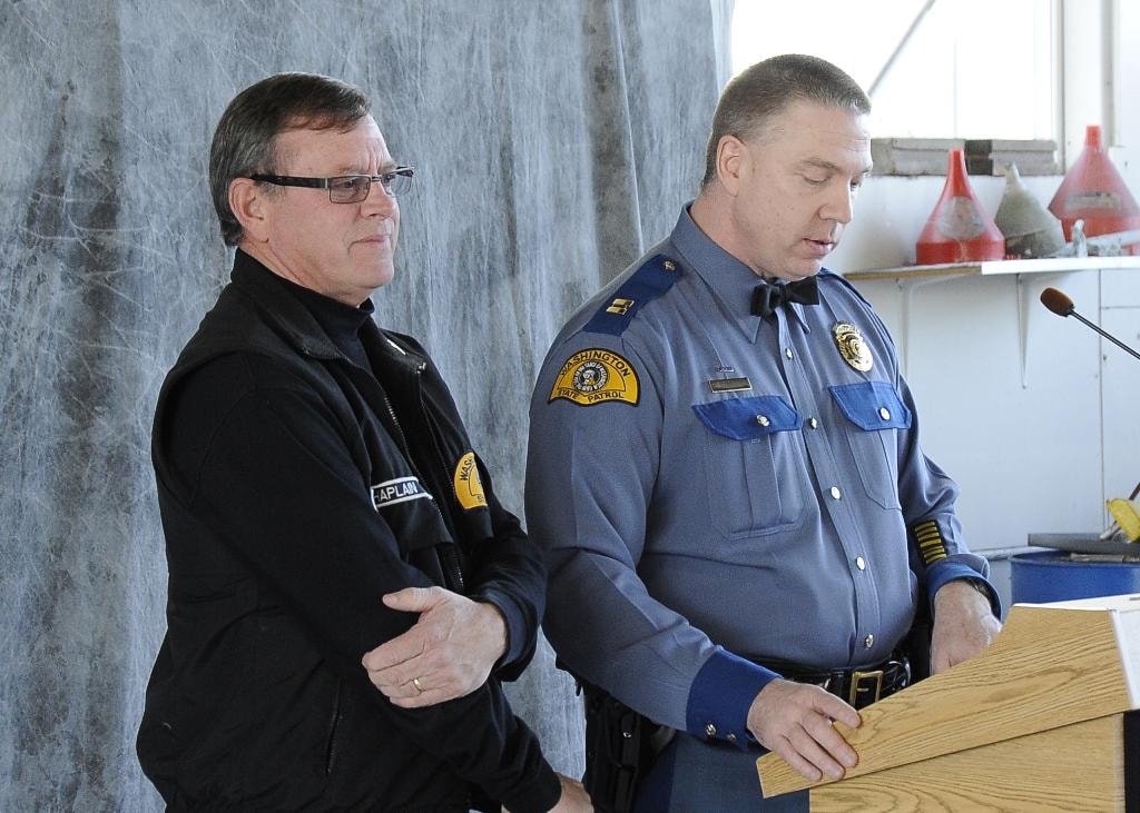 Mike Neil alongside a WSP officer at a podium event