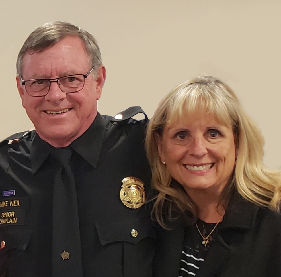 Mike Neil in Senior Chaplain uniform with Sue