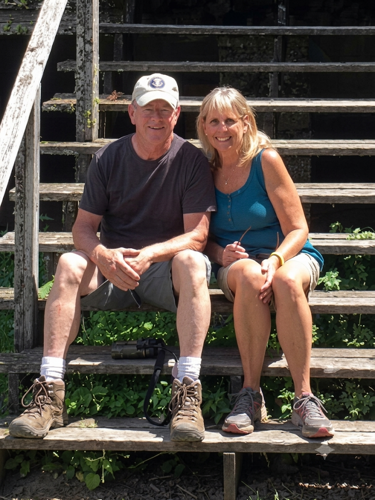 Mike and Sue Neil sitting on steps outdoors