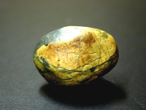 The rock — a smooth golden stone found by Mike Neil after Susanne's passing